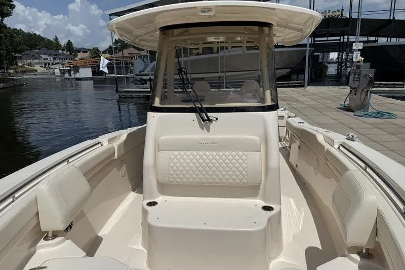 Slide: The Image of 2024 Grady-White Canyon 306 boat docked at marina, showcasing spacious seating and helm. - 15