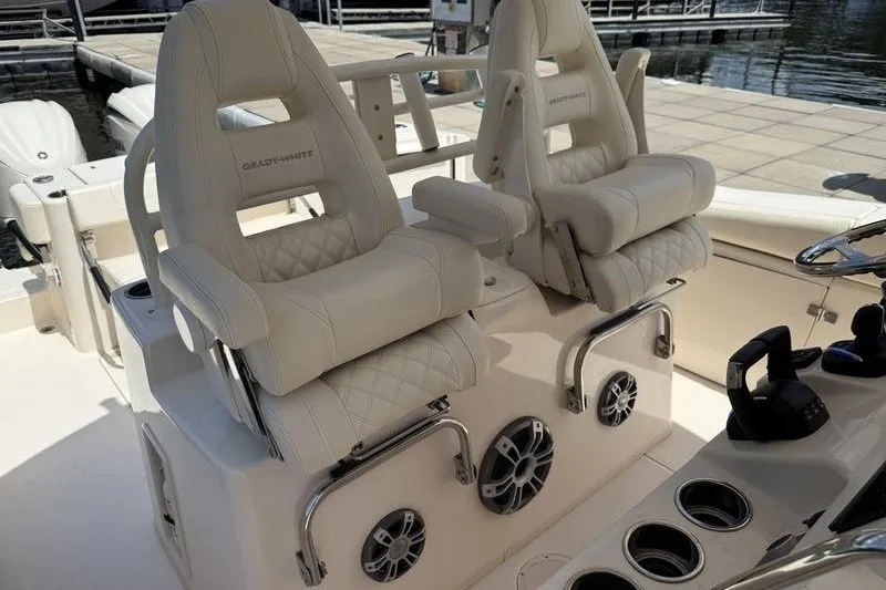 Slide: The Image of 2024 Grady-White Canyon 306 boat interior with luxurious seating and modern controls. - 18