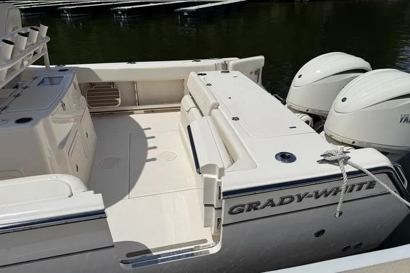 Slide: The Image of 2024 Grady-White Canyon 306 boat with dual engines, spacious deck, and sleek design. - 23
