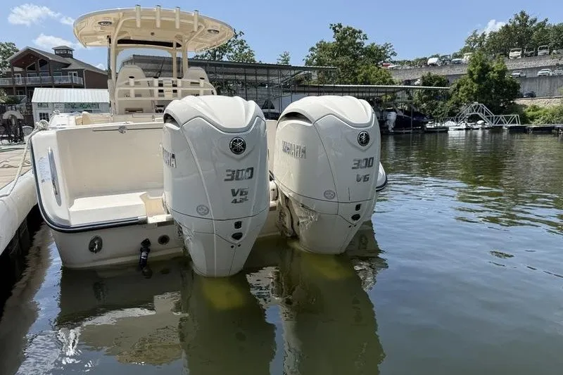 Slide: The Image of 2024 Grady-White Canyon 306 boat with twin Yamaha 300 V6 engines docked on a sunny day. - 11