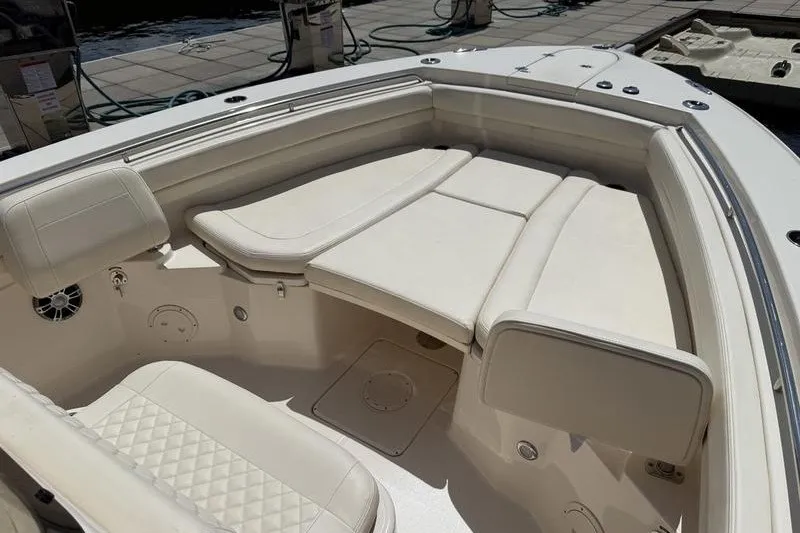 Slide: The Image of 2024 Grady-White Canyon 306 boat interior with cushioned seating and sleek design. - 12
