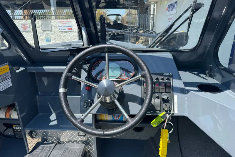 Slide: The Image of 2021 Hewescraft 180 River Runner dashboard with steering wheel and control panel. - 11