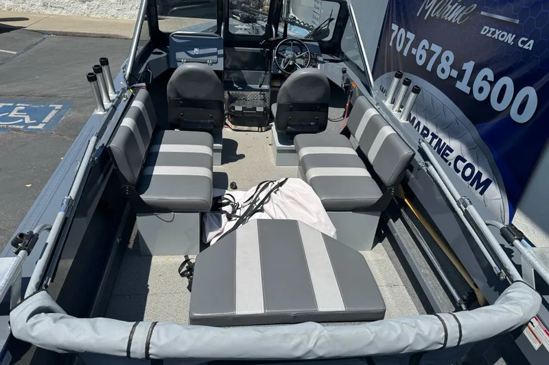 Slide: The Image of 2021 Hewescraft 180 River Runner interior with gray seating and fishing rod holders. - 9