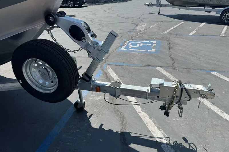 Slide: The Image of Trailer hitch of a 2021 Hewescraft 180 River Runner in a parking lot. - 2