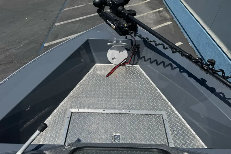 Slide: The Image of 2021 Hewescraft 180 River Runner boat deck with diamond plate flooring and trolling motor. - 13