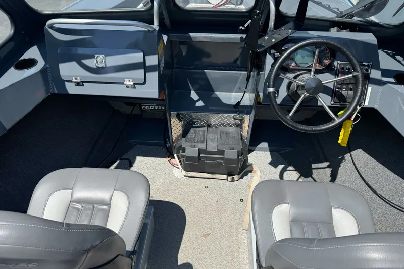 Slide: The Image of 2021 Hewescraft 180 River Runner interior with steering wheel and seating. - 10