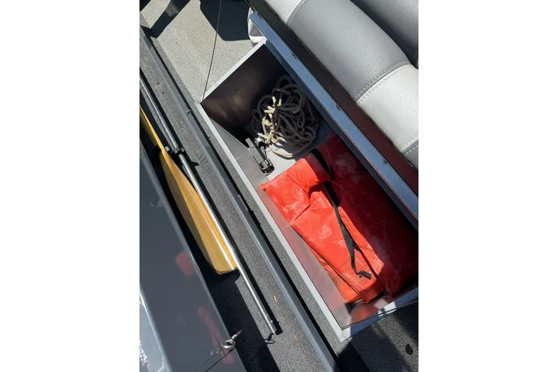 Slide: The Image of Storage compartment in 2021 Hewescraft 180 River Runner with rope and life jacket. - 16