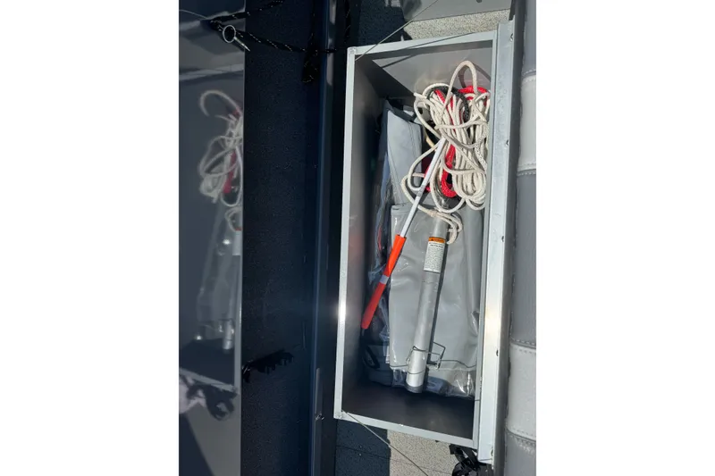 Slide: The Image of Storage compartment on a 2021 Hewescraft 180 River Runner with ropes and equipment. - 17