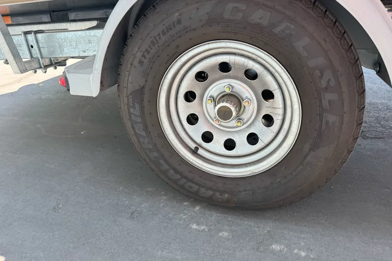 Slide: The Image of Trailer wheel of a 2021 Hewescraft 180 River Runner, featuring Carlisle tire. - 3