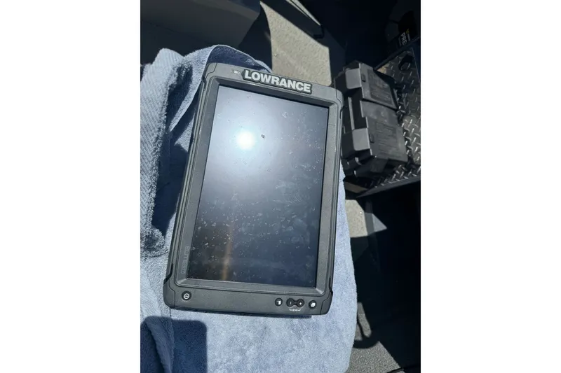 Slide: The Image of Lowrance device on a 2021 Hewescraft 180 River Runner boat, resting on a towel. - 12