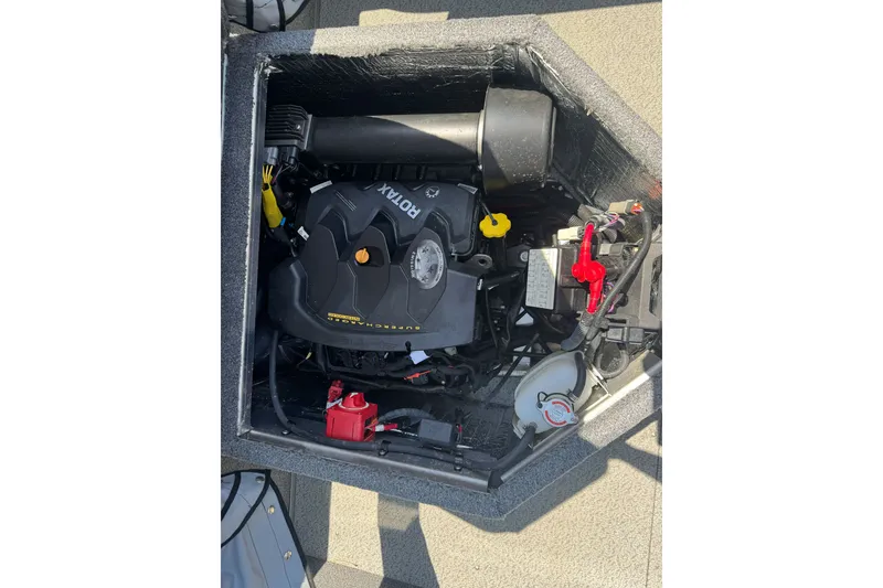 Slide: The Image of Engine compartment of a 2021 Hewescraft 180 River Runner boat, featuring a Rotax engine. - 19