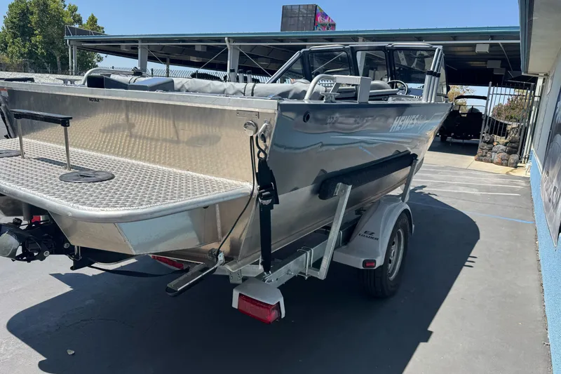 Slide: The Image of 2021 Hewescraft 180 River Runner boat on trailer, parked outdoors. - 5