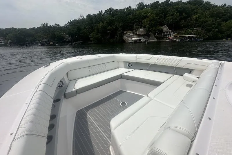 Slide: The Image of Luxurious seating area on a 2021 Regal 38 SAV boat, with scenic lake view. - 29