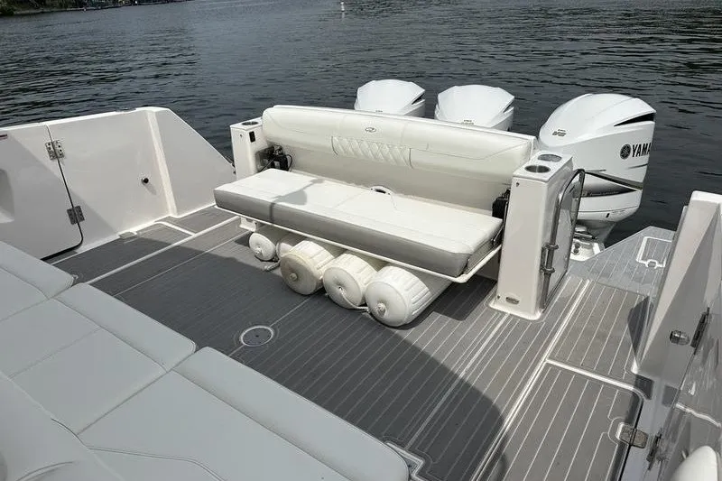 Slide: The Image of 2021 Regal 38 SAV boat with Yamaha engines, featuring a spacious deck and seating area. - 22