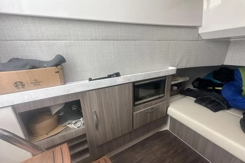 Slide: The Image of Interior of a 2021 Regal 38 SAV boat featuring a compact kitchen area. - 31