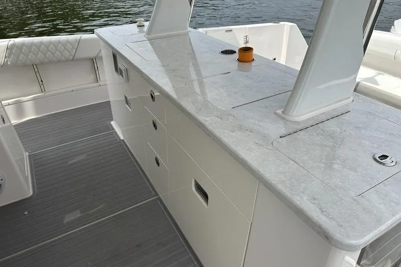 Slide: The Image of 2021 Regal 38 SAV boat interior with sleek countertop and storage drawers. - 20