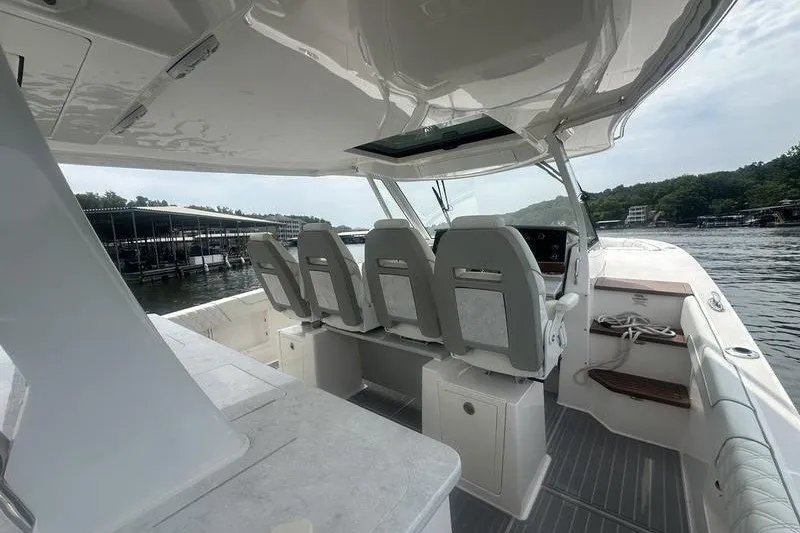 Slide: The Image of 2021 Regal 38 SAV boat interior with helm seats and open water view. - 26