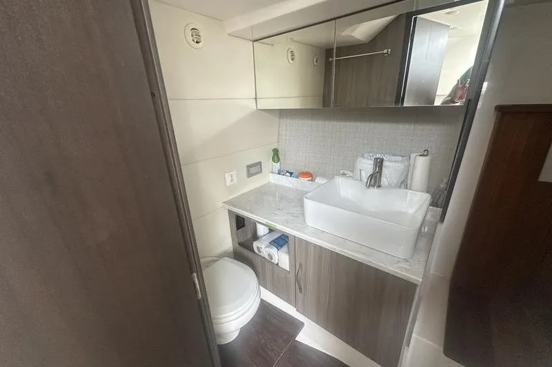 Slide: The Image of Modern bathroom in a 2021 Regal 38 SAV yacht, featuring sleek cabinetry and a vessel sink. - 19