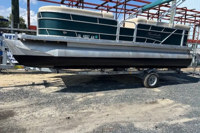 Slide: The Image of 2015 Godfrey 2286 Sweetwater Pontoon on trailer, parked outdoors. - 1