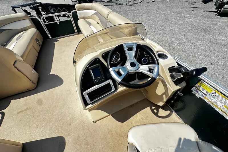 Slide: The Image of 2015 Godfrey 2286 Sweetwater Pontoon boat interior with steering wheel and seating. - 7