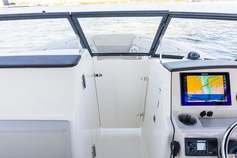 Slide: The Image of Manufacturer Provided Image: 2026 Boston Whaler 210 Vantage boat interior with navigation system and windshield view. - 9