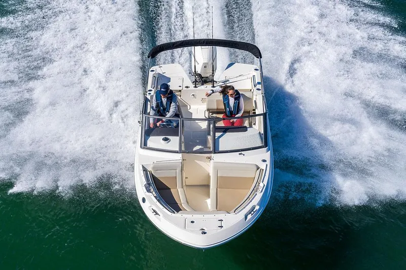 Slide: The Image of Manufacturer Provided Image: 2026 Boston Whaler 210 Vantage boat cruising on water, aerial view. - 1