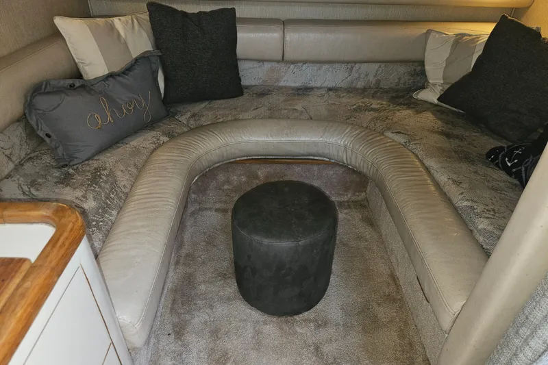 Slide: The Image of Interior of 1996 Sea Ray 370 Express Cruiser with cozy seating and decorative pillows. - 15
