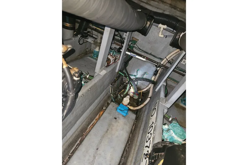 Slide: The Image of Engine compartment of a 1996 Sea Ray 370 Express Cruiser, showing mechanical components and wiring. - 38