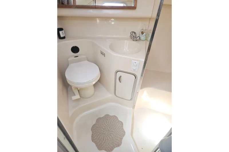 Slide: The Image of Bathroom interior of 1996 Sea Ray 370 Express Cruiser with toilet and sink. - 26