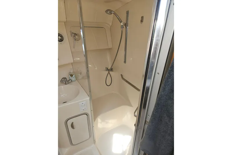 Slide: The Image of 1996 Sea Ray 370 Express Cruiser bathroom with shower and sink. - 25