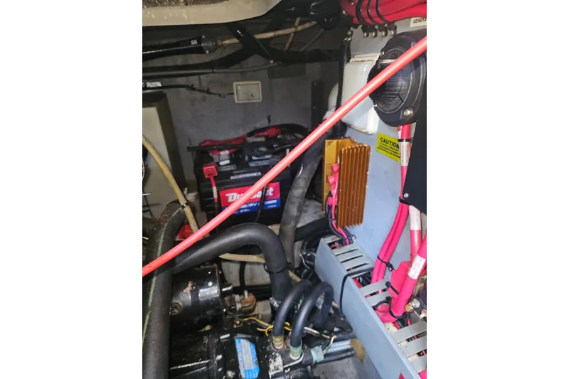 Slide: The Image of Engine compartment of a 1996 Sea Ray 370 Express Cruiser with visible battery and wiring. - 35