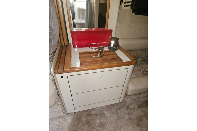Slide: The Image of 1996 Sea Ray 370 Express Cruiser interior with wooden countertop and storage drawers. - 16