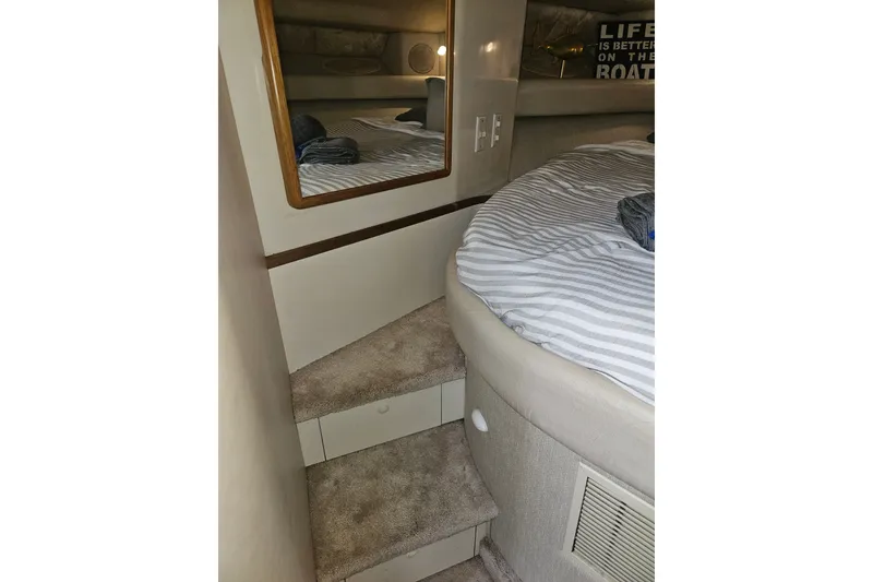 Slide: The Image of Interior cabin of 1996 Sea Ray 370 Express Cruiser with bed and mirror. - 23