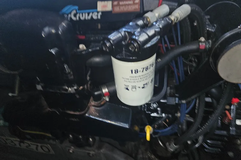 Slide: The Image of Engine compartment of a 1996 Sea Ray 370 Express Cruiser with visible components. - 36