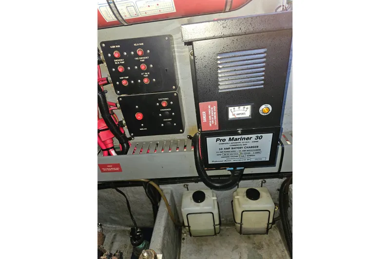 Slide: The Image of Electrical panel and Pro Mariner 30 battery charger in 1996 Sea Ray 370 Express Cruiser. - 34