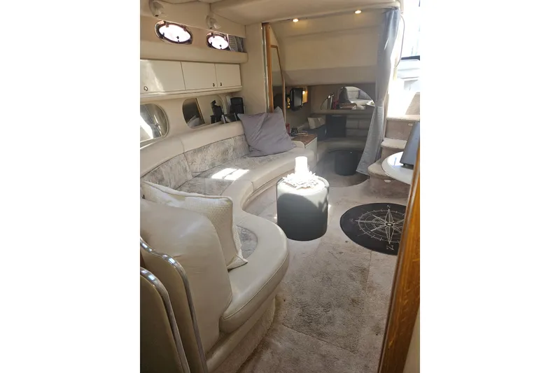 Slide: The Image of Luxurious interior of 1996 Sea Ray 370 Express Cruiser with plush seating and elegant decor. - 18