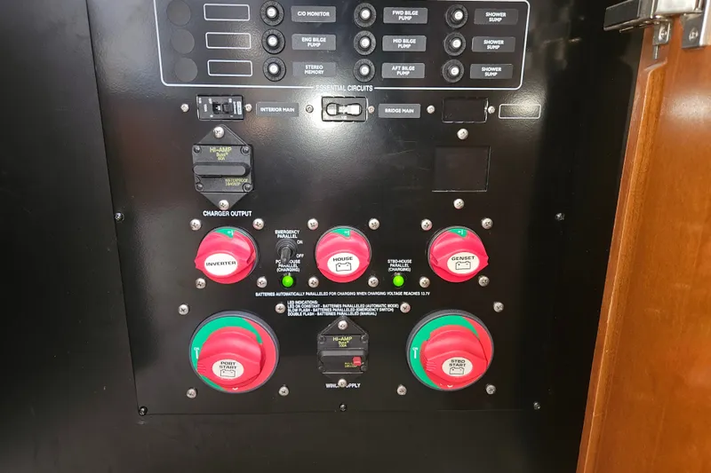 Slide: The Image of Electrical control panel of a 2005 Meridian 368 Motoryacht with labeled switches and dials. - 56