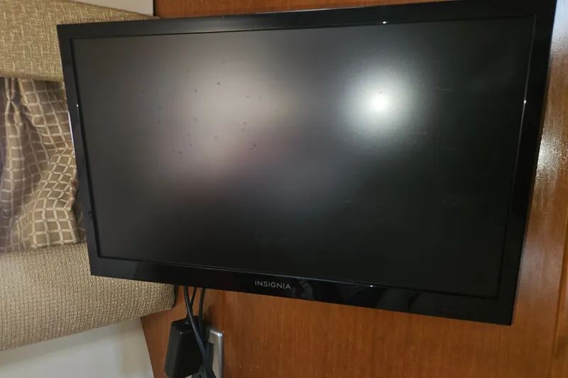 Slide: The Image of Insignia TV mounted on a 2005 Meridian 368 Motoryacht interior wall. - 36