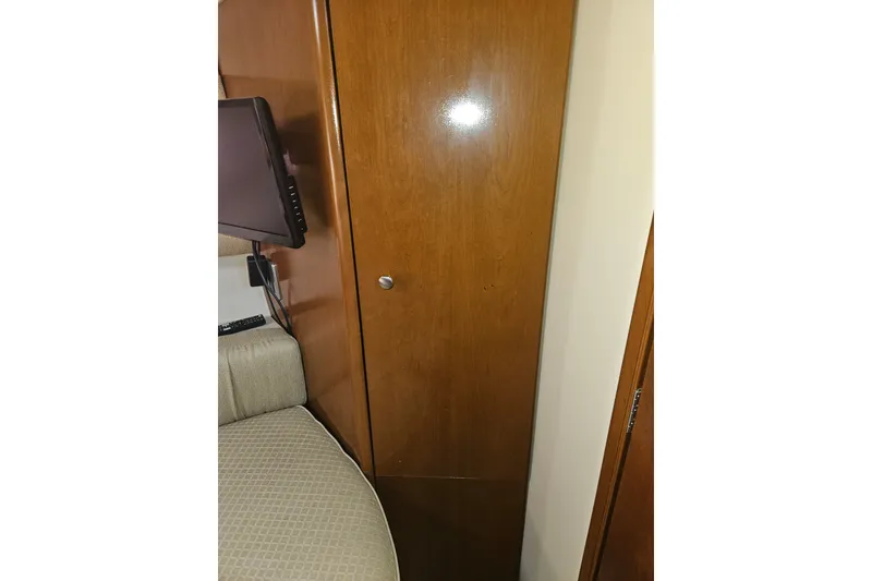 Slide: The Image of Interior of 2005 Meridian 368 Motoryacht featuring wooden cabinet and mounted TV. - 29