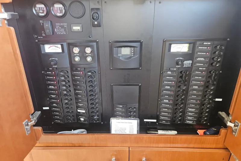 Slide: The Image of Electrical panel inside a 2005 Meridian 368 Motoryacht, featuring various switches and gauges. - 55