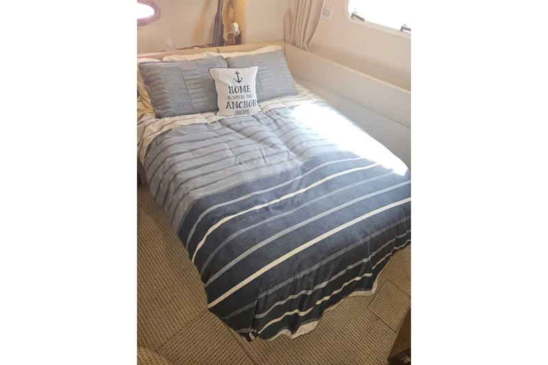 Slide: The Image of Cozy bedroom in 2005 Meridian 368 Motoryacht with nautical-themed bedding. - 27
