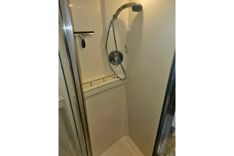 Slide: The Image of Shower area in 2005 Meridian 368 Motoryacht, featuring chrome fixtures and beige walls. - 35