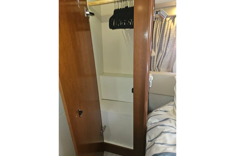 Slide: The Image of Wooden closet interior on 2005 Meridian 368 Motoryacht with hangers and shelves. - 30