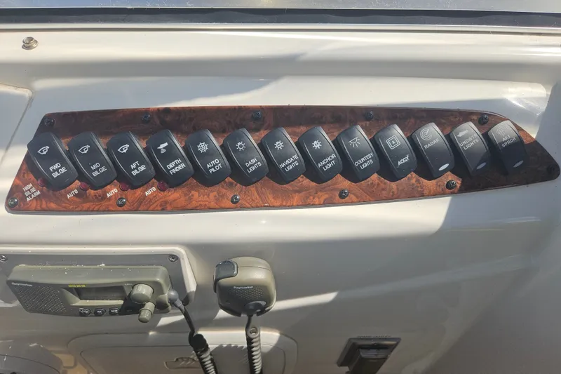 Slide: The Image of Control panel of a 2005 Meridian 368 Motoryacht with various switches and equipment. - 52