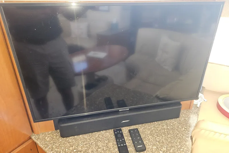 Slide: The Image of Flat-screen TV with Bose soundbar and remotes on a 2005 Meridian 368 Motoryacht. - 22