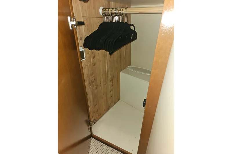 Slide: The Image of Closet interior of 2005 Meridian 368 Motoryacht with hangers and wooden finish. - 43