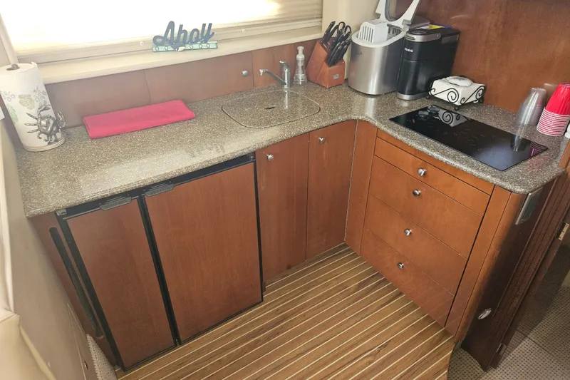 Slide: The Image of Compact kitchen in 2005 Meridian 368 Motoryacht with wooden cabinets and modern appliances. - 23