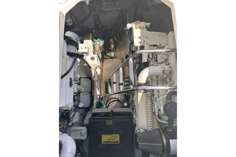 Slide: The Image of Engine compartment of a 2007 Sea Ray 48 Sundancer yacht, showcasing mechanical components. - 64