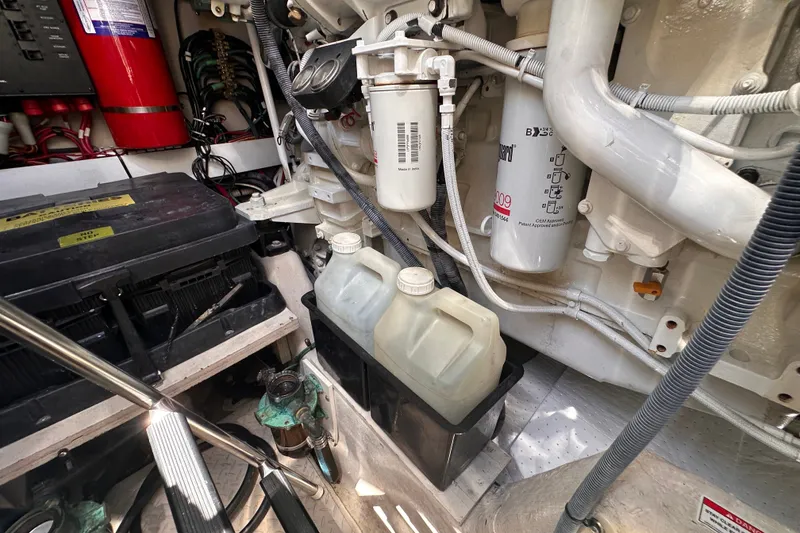 Slide: The Image of Engine room of 2007 Sea Ray 48 Sundancer with filters, cables, and containers. - 84