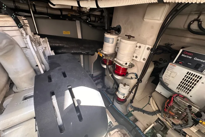 Slide: The Image of Engine room of 2007 Sea Ray 48 Sundancer with generator and fuel filters visible. - 70